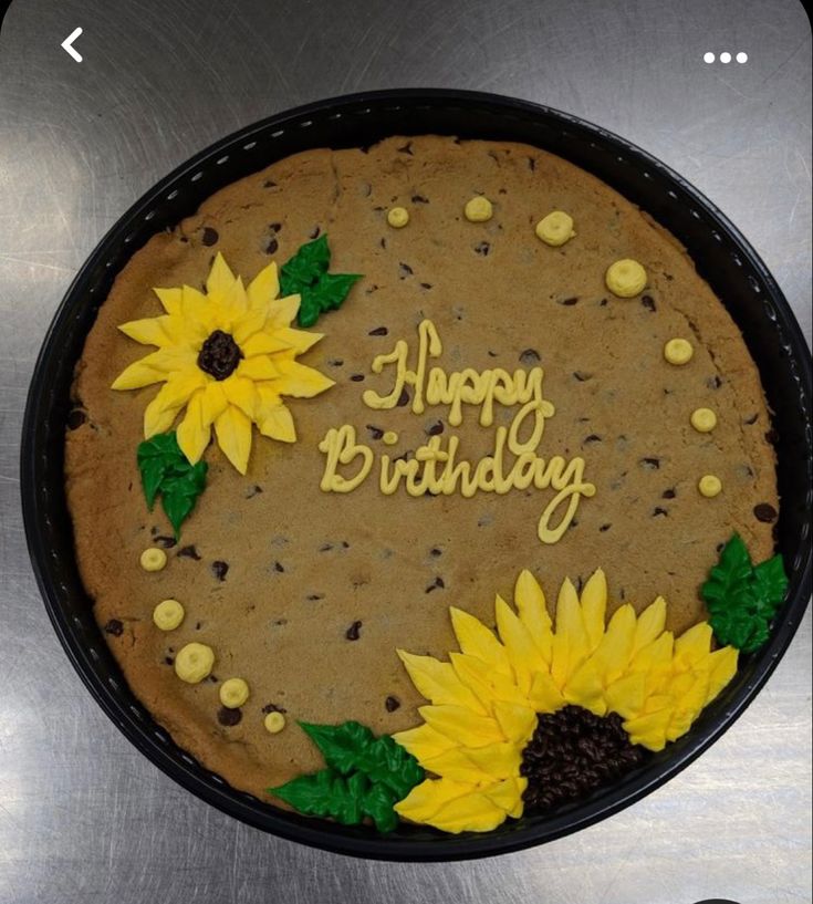 a birthday cake decorated with sunflowers and the words happy birthday written on it