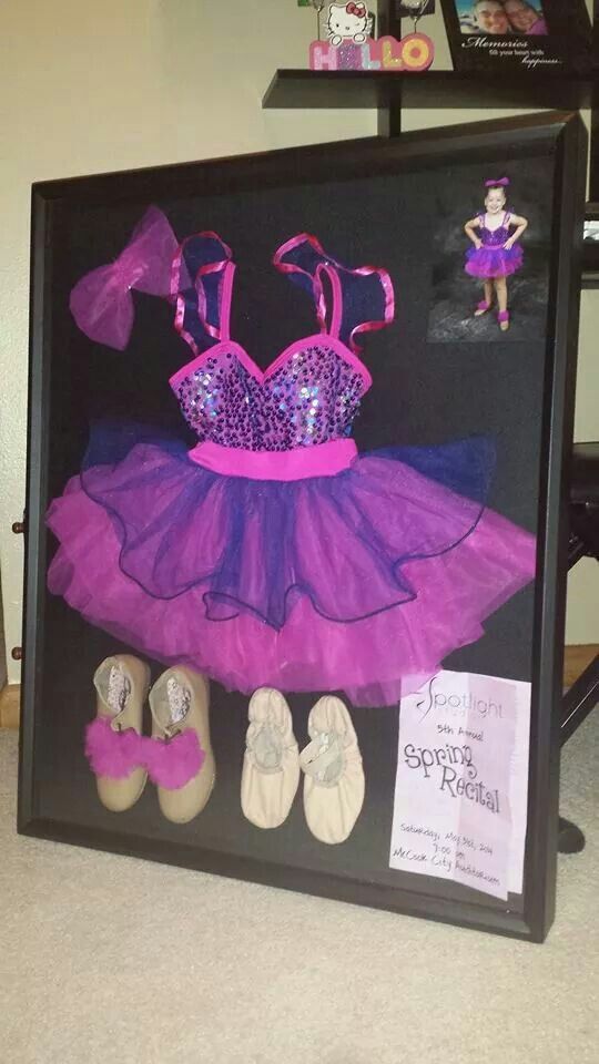 a purple dress and shoes are on display in a shadow box with pink trimmings