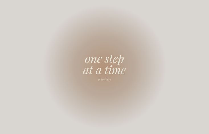 the words one step at a time are written in white on a light brown background