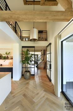 a large open floor plan with wooden floors and high ceilings is shown in this modern home