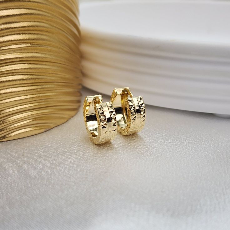 Beautiful solid 14k gold fully diamond cut and mirror huggie earrings. Perfect for every day and every occasion. These earrings are versatile, comfortable and everlasting. Very secure and lightweight. You will never want to take them off. We added diamond cut texture on the sides of the earrings to make them extra sparkling. Perfect gift for yourself or your love ones. 14k gold will not tarnish or rust. Huggies earrings sit close to the earlobe. Materials: 14k Gold Diameter: 14mm Thickness: 5mm Solid Gold Jewelry, Perfect Gift For Her, Huggies Earrings, Jewelry Earrings Hoops, Gold Diamond, Gold Jewelry, Diamond Cuts, Perfect Gift, Jewelry Earrings