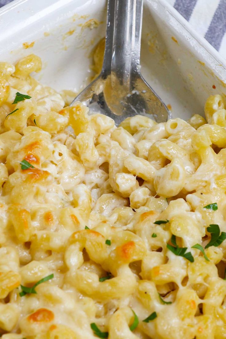 macaroni and cheese in a white dish with a spoon