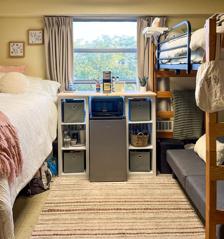 a bedroom with bunk beds, desk and storage drawers in it's center area