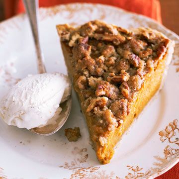 a slice of pecan pie on a plate with a scoop of vanilla ice cream