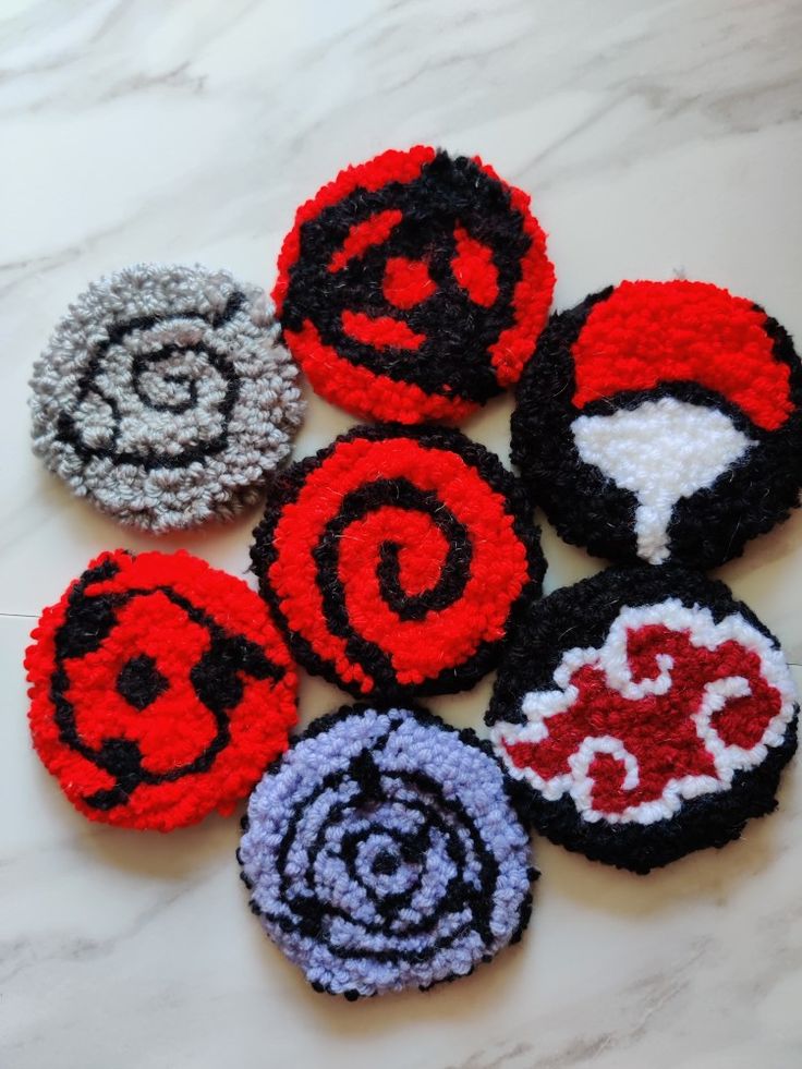 six different types of brooches on a marble surface with white and black designs