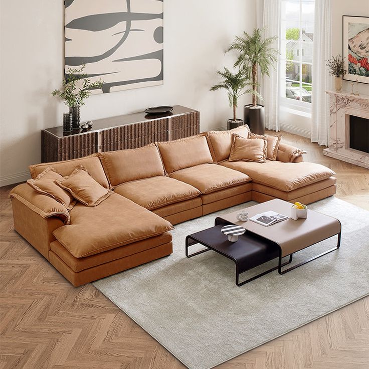 a living room with a large sectional couch and coffee table in front of a fireplace