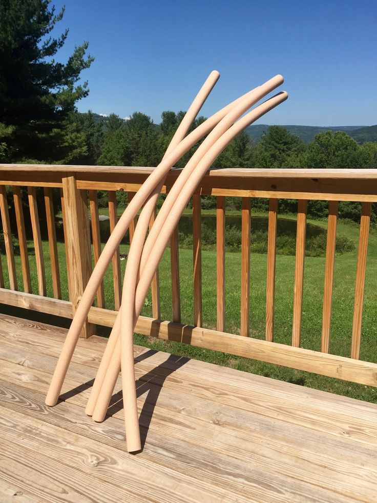 three wooden sticks sticking out of the ground on a deck