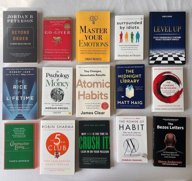 there are many different books on the table in this picture, each with their own title