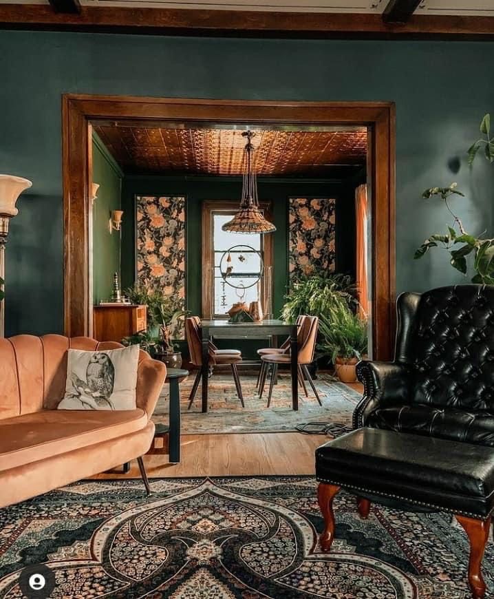 a living room filled with furniture next to a dining room table and chairs in front of a window