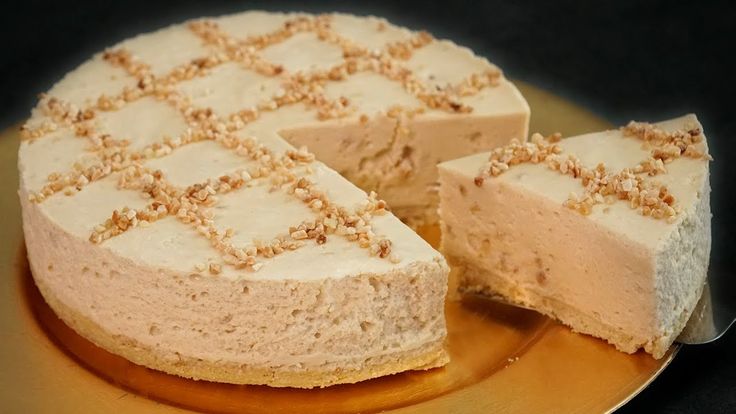 a cheesecake on a gold plate with one slice cut out