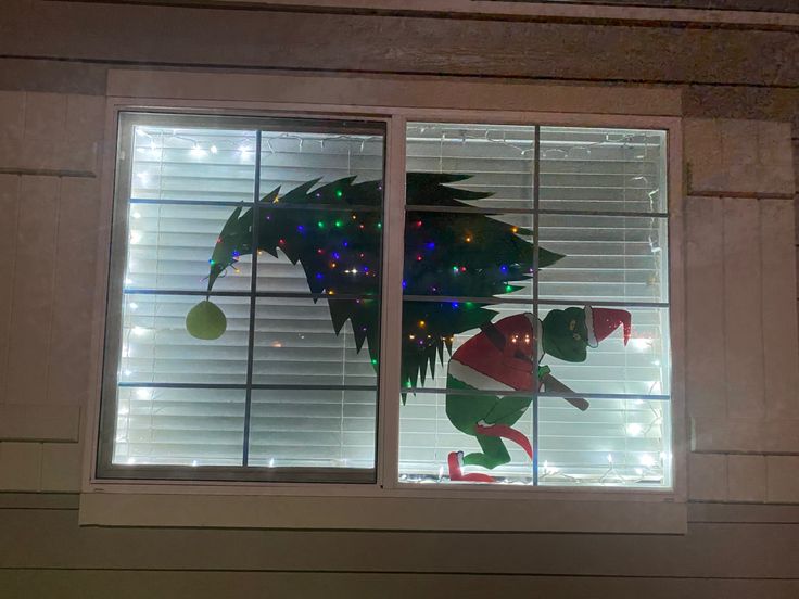 two windows decorated with christmas decorations and lights