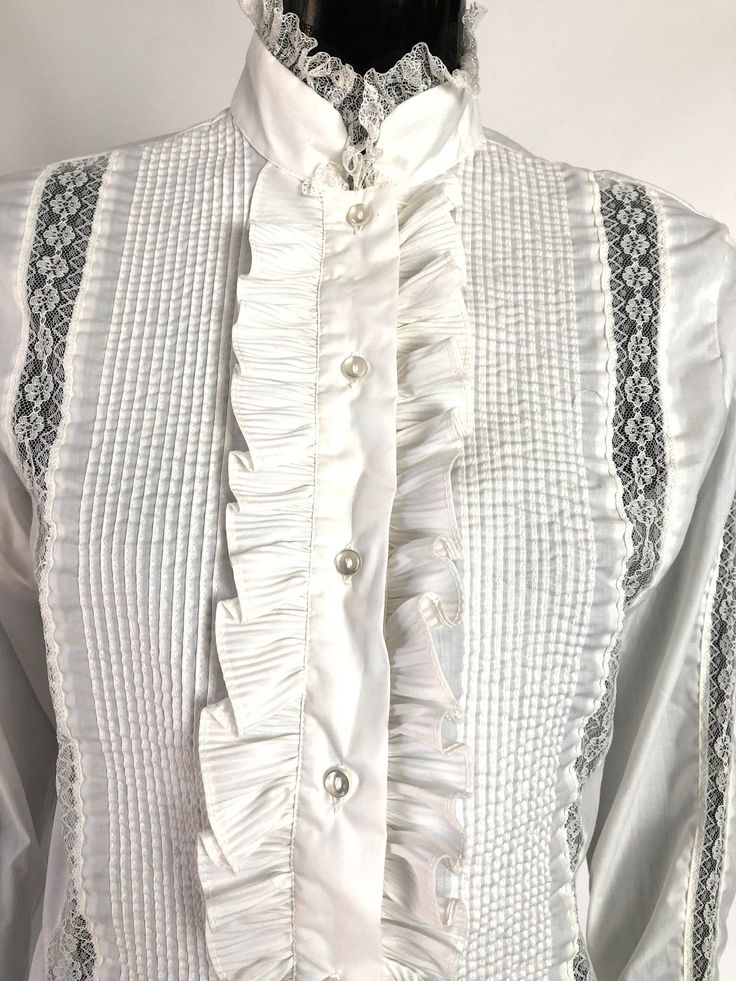 Super stunning. Immaculate. She's the lovechild of a white button down and a tuxedo shirt. She would be amazing with high -waisted slacks or bell bottom pants. Size 38- (6 in US) Made by Melray Made of polyester and cotton Fitted White Victorian Blouse, White Fitted Victorian Blouse, Elegant Fitted Blouse With Covered Buttons, Classic Fitted Wedding Blouse, Formal Fitted Ruffled Blouse, Classic Formal Blouse With Pearl Buttons, Formal Fitted Ruffle Blouse, Fitted Ruffled Blouse For Formal Occasions, Fitted Ruffle Blouse For Formal Occasions