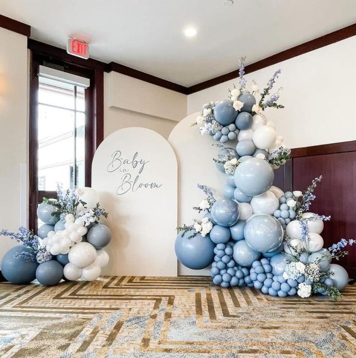 an arrangement of blue and white balloons is on display