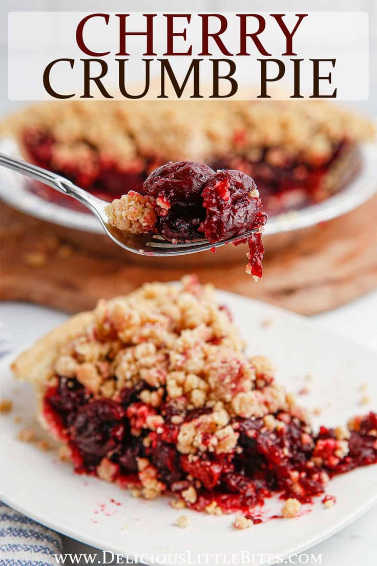 a slice of cherry crumb pie on a white plate with a fork in it