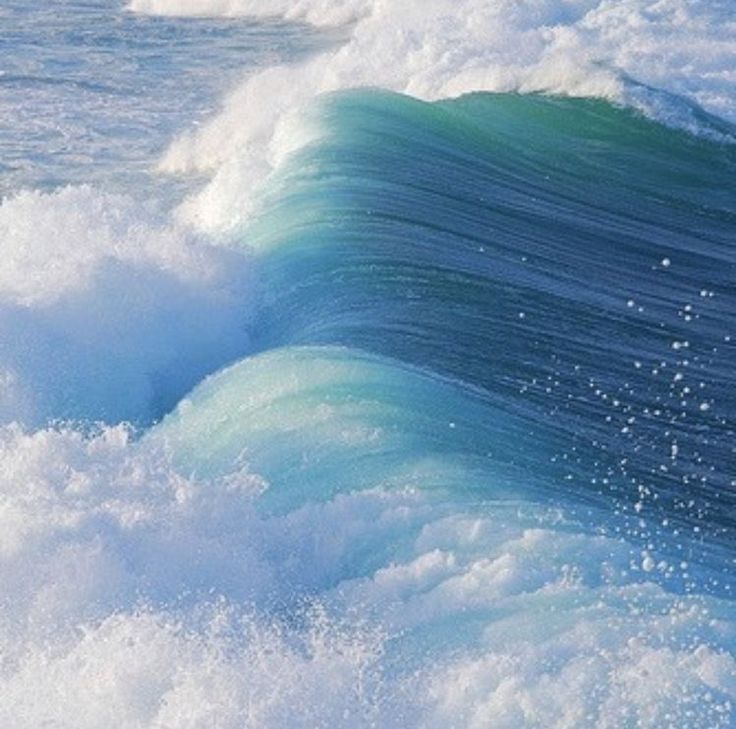 an ocean wave is breaking on the water and it looks like something out of space