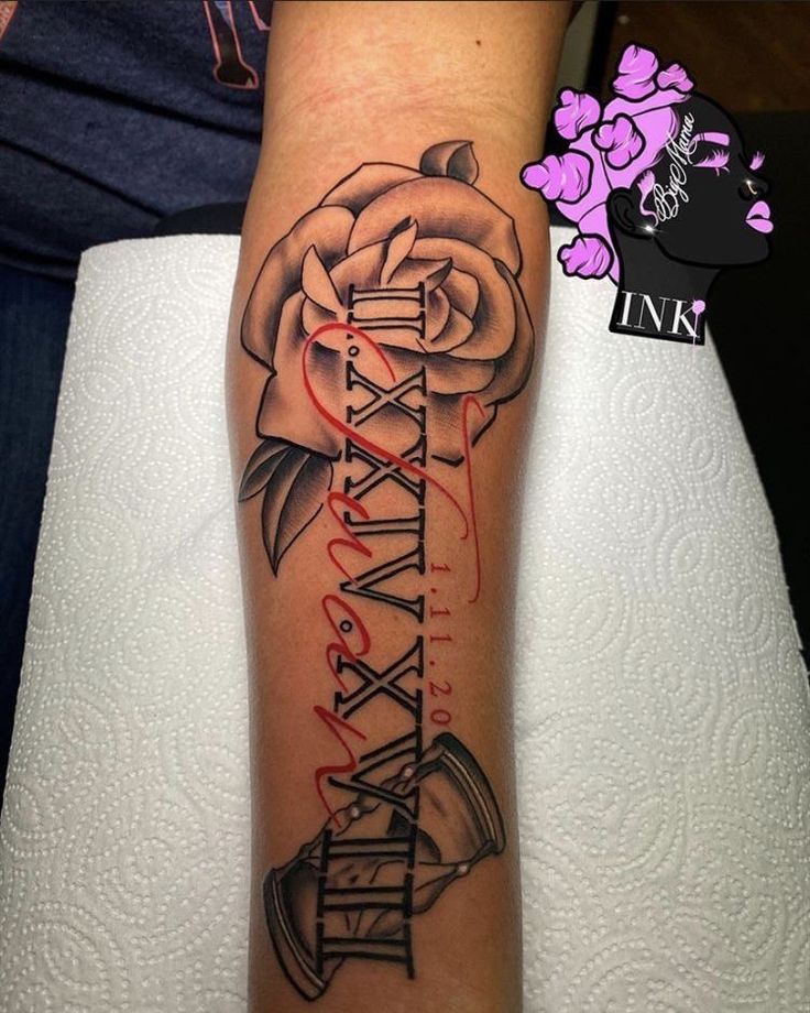 a woman's arm with a rose and some writing on the side of it