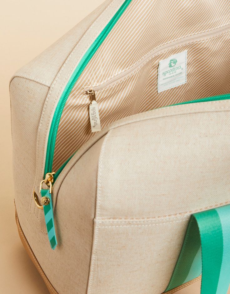 This travel bag is ready to go at a moment's notice. Spontaneous and spacious, our zip-top Armada Duffle is made with an easy-to-wipe-clean, splash-proof, stain-resistant, laminated cotton and jute with three deep slip pockets on the front side. On the backside, this traveler's-best-friend features a zip pocket and trolley sleeve to easily carry atop your suitcase! Loungewear Capsule, Beach Towel Blanket, Spartina 449, Beach Shop, Straw Bags, Duffel Bags, Embroidered Bag, Linen Bag, Beach Accessories