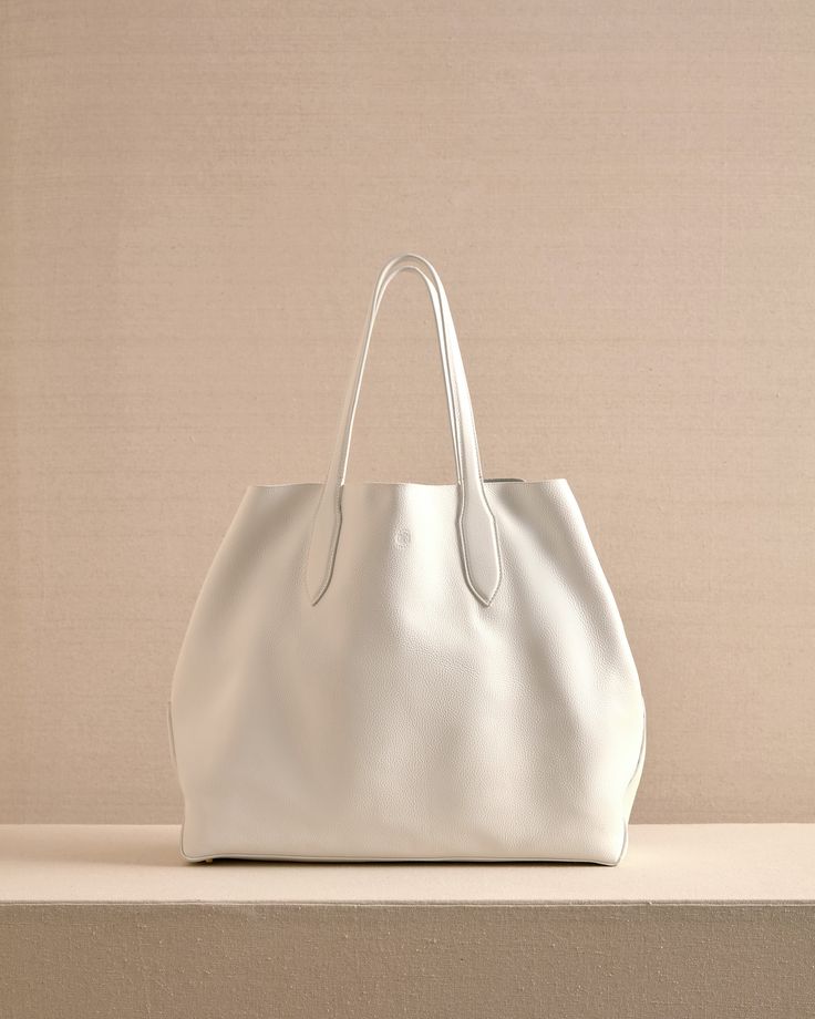 The Eleanor Tote is the perfect slouchy, easy tote bag. Crafted from the softest Tumbled Grain Calfskin leather in Ivory with tonal stitching, the Eleanor Tote features a third strap which fastens using our signature collar studs. Slouchy Tote, Light Sapphire, Mark Cross, Rings Jewelry Fashion, By Grace, Grace Kelly, Handbag Shoes, Rear Window, Travel Companion