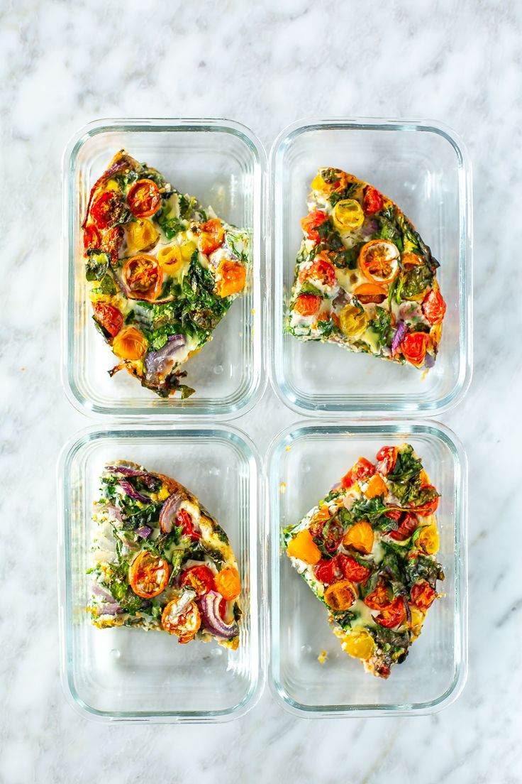 four glass containers with food in them on a marble counter top, one has three slices of pizza and the other is half eaten