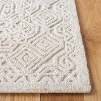 a white rug with an intricate design on the floor