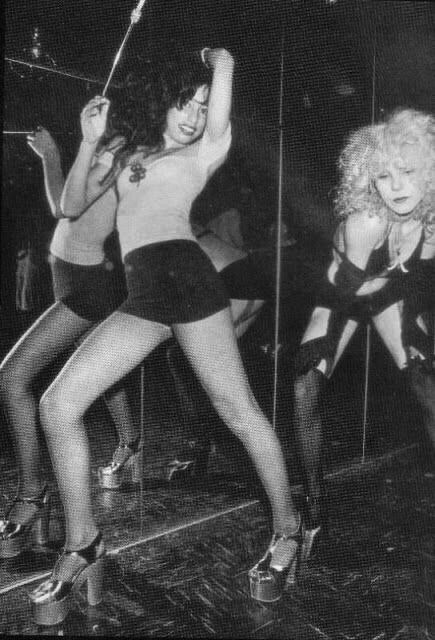 two women in short shorts and high heels on stage