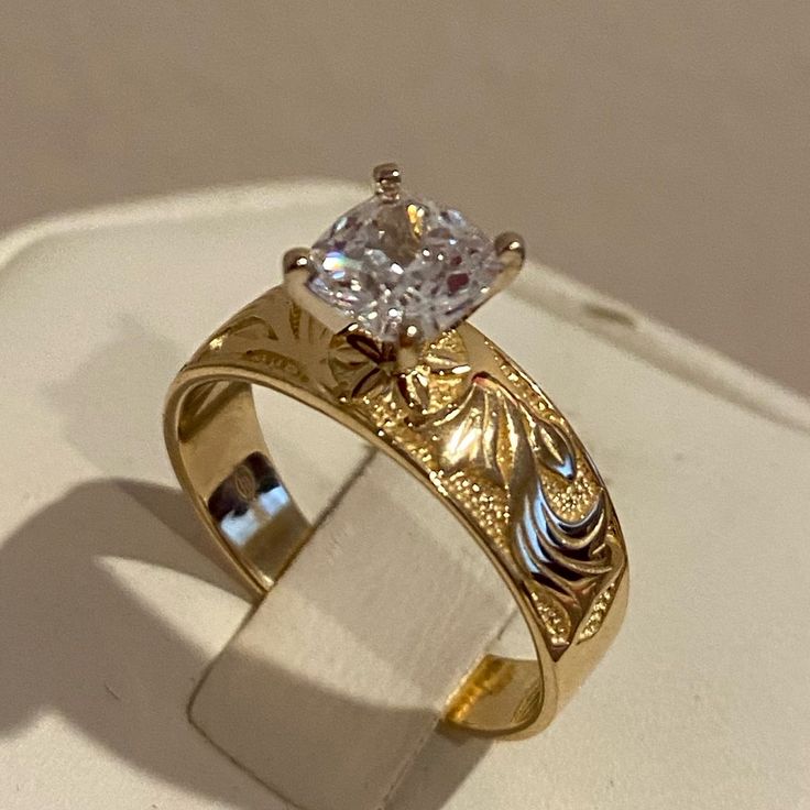 a gold ring with a diamond in the center