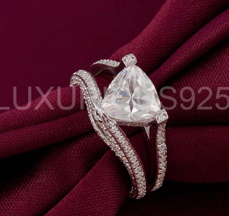 a diamond ring on top of a red cloth