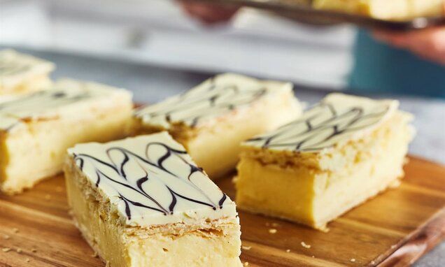 several pieces of cake sitting on top of a wooden cutting board