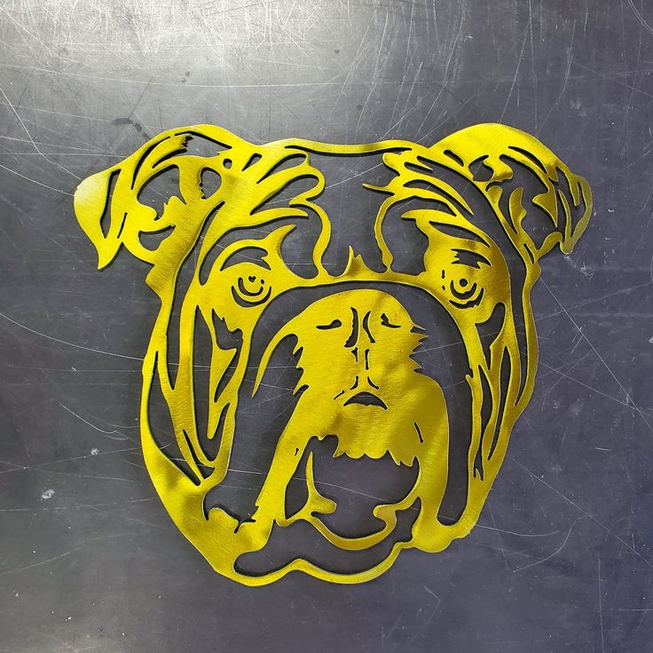 a dog's head is shown on the side of a metal surface with yellow paint