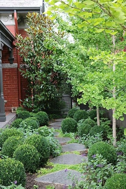 a stone path in the middle of a garden