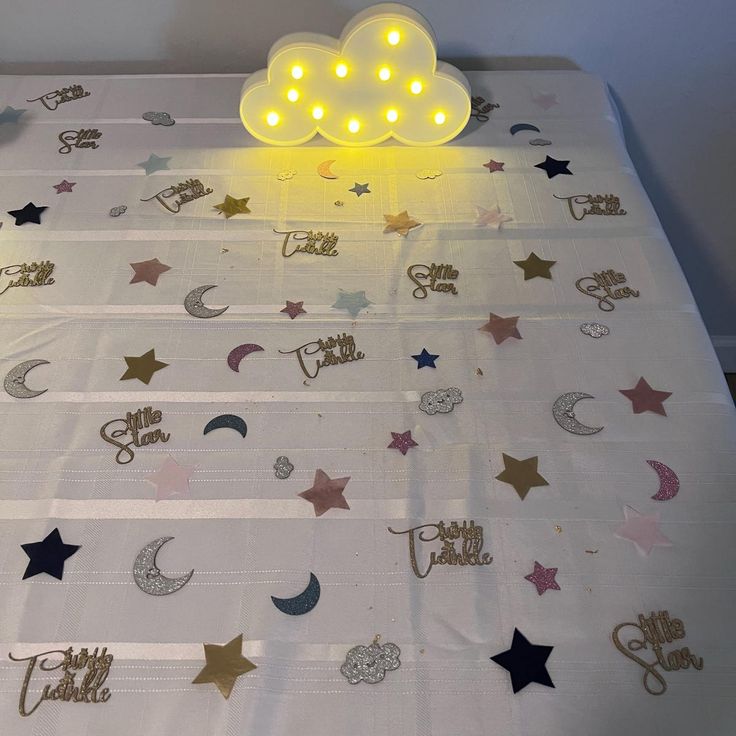 a bed topped with lots of stars and lights