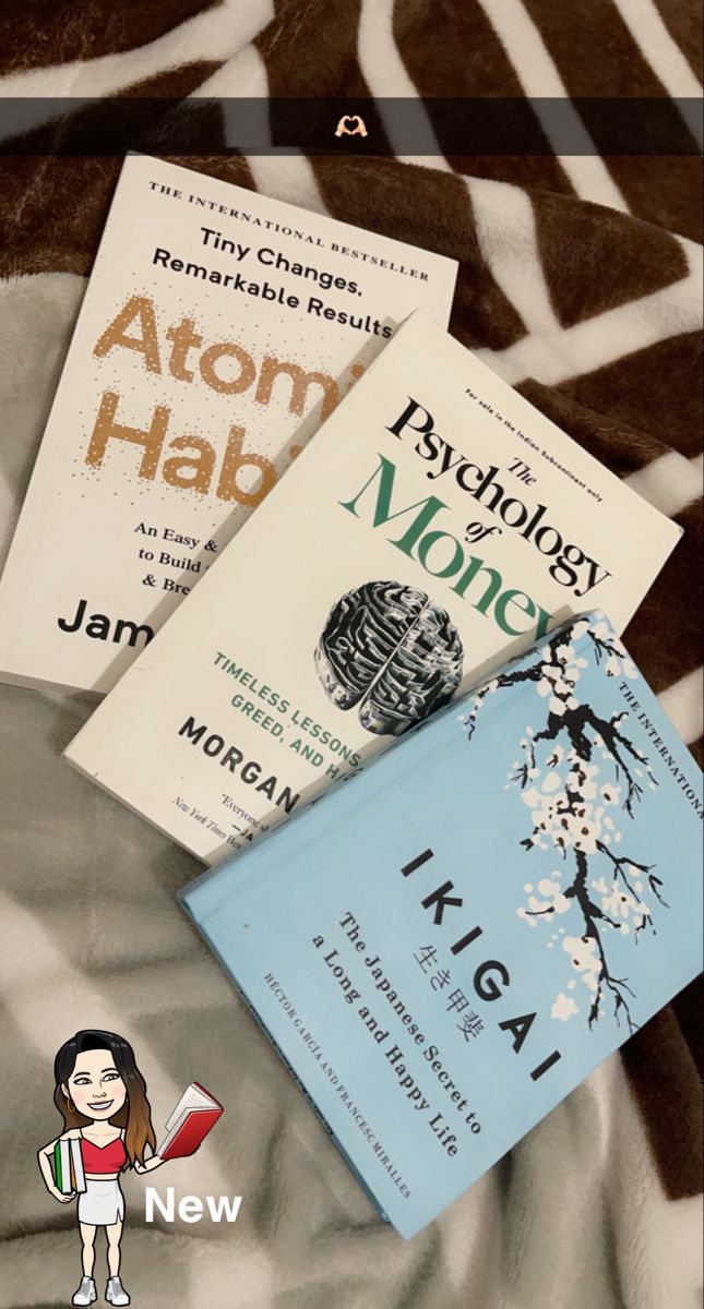 three books sitting on top of a bed next to each other