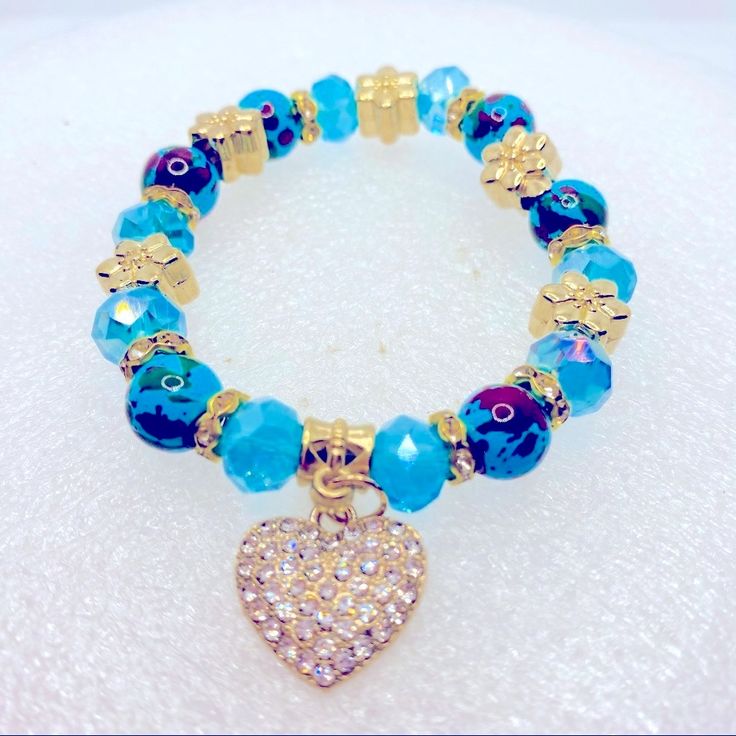 Bracelet Crystal Heart In Turquoise And Golden Beads. Very Brilliant! Brand New In Packaging! Some Beads Are Hand Painted. Blue Heart-shaped Beaded Bracelets, Blue Heart-shaped Beaded Bracelet, Blue Charm Bracelet With Heart Beads And Adjustable Fit, Adjustable Blue Charm Bracelet With Heart Beads, Adjustable Blue Heart Bracelet With Round Beads, Adjustable Blue Beaded Heart Bracelet, Blue Beaded Bracelets With Heart Charm For Gift, Turquoise Bracelets With Heart And Round Beads, Turquoise Heart-shaped Beaded Bracelets