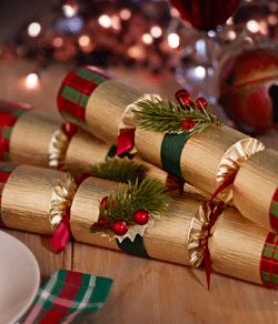 four wrapped christmas crackers sitting on top of a table