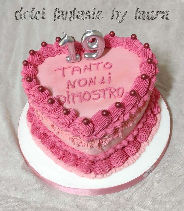 a pink heart shaped cake on top of a white plate with the number twenty nine