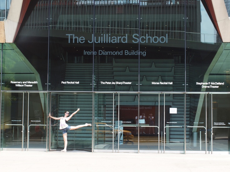 a woman is standing in front of a building