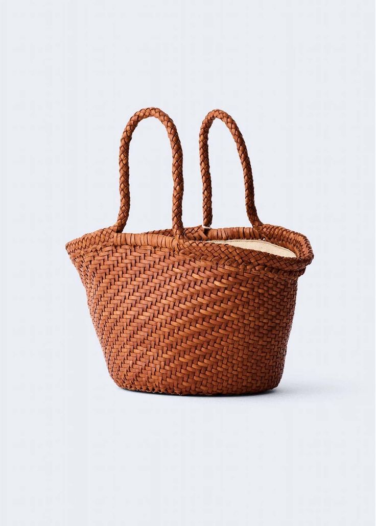 Introducing Martha - a chic woven leather basket handbag designed for easy hand-carrying. Martha features a sewn-in cotton drawstring inner bag for convenient closure, adding a touch of security while preserving the sleek design. With its diagonal weaving reminiscent of traditional wicker baskets, Martha seamlessly blends classic aesthetics with modern functionality. An antiqued St. Christopher medal charm, in homage to the patron saint of travelers, is hand-sewn inside each and every bag — this detail serves as the signature mark of authenticity of Dragon Diffusion. Buffalo leather Top width: 15"; bottom width: 7.5"; length: 8.3" Handle drop: 6.5" Care instructions India Style No. 8068948 Natural Bucket Bag With Intrecciato Weave, Natural Woven Leather Bucket Bag, Beach Basket Straw Bag With Intrecciato Weave, Natural Straw Bag With Intrecciato Weave And Top Handle, Basket-shaped Straw Bag With Intrecciato Weave, Rectangular Natural Bucket Bag With Intrecciato Weave, Vacation Bucket Bag Tote With Intrecciato Weave, Leather Straw Bag With Intrecciato Weave, Straw Bucket Shoulder Bag With Intrecciato Weave