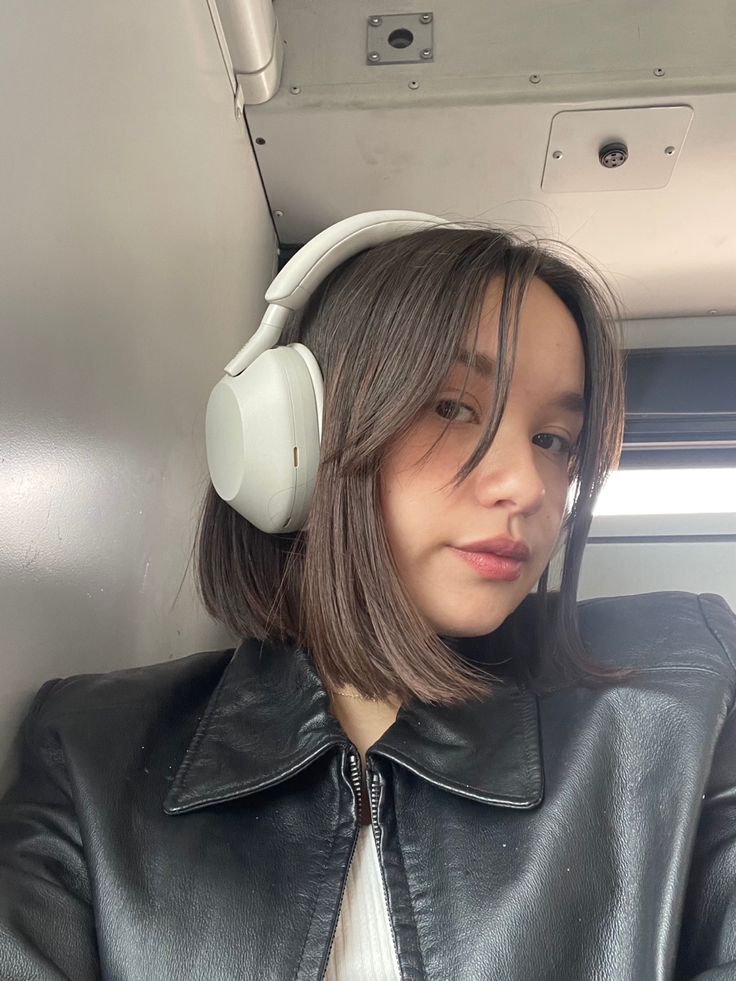 a woman wearing headphones on an airplane