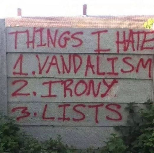 graffiti on the side of a building that says things i hate 4 vandalism 2 irony 3 lists