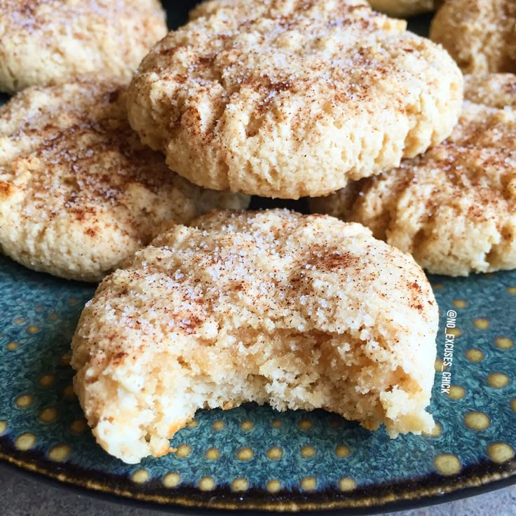 powdered sugar cookies sitting on top of a blue plate