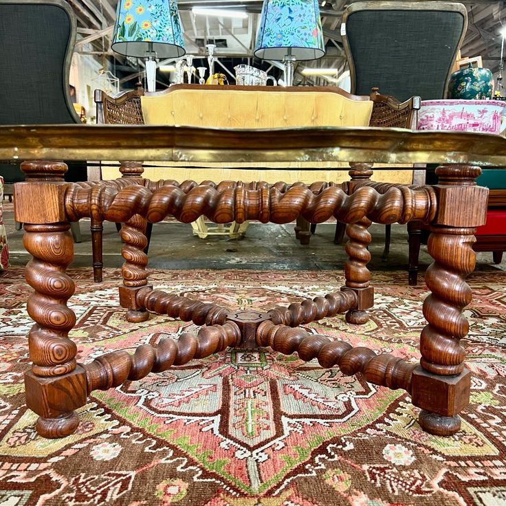 a wooden table sitting on top of a rug