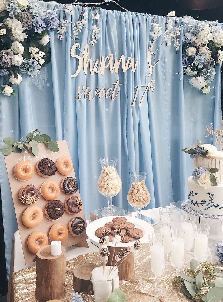 a table topped with lots of donuts and desserts