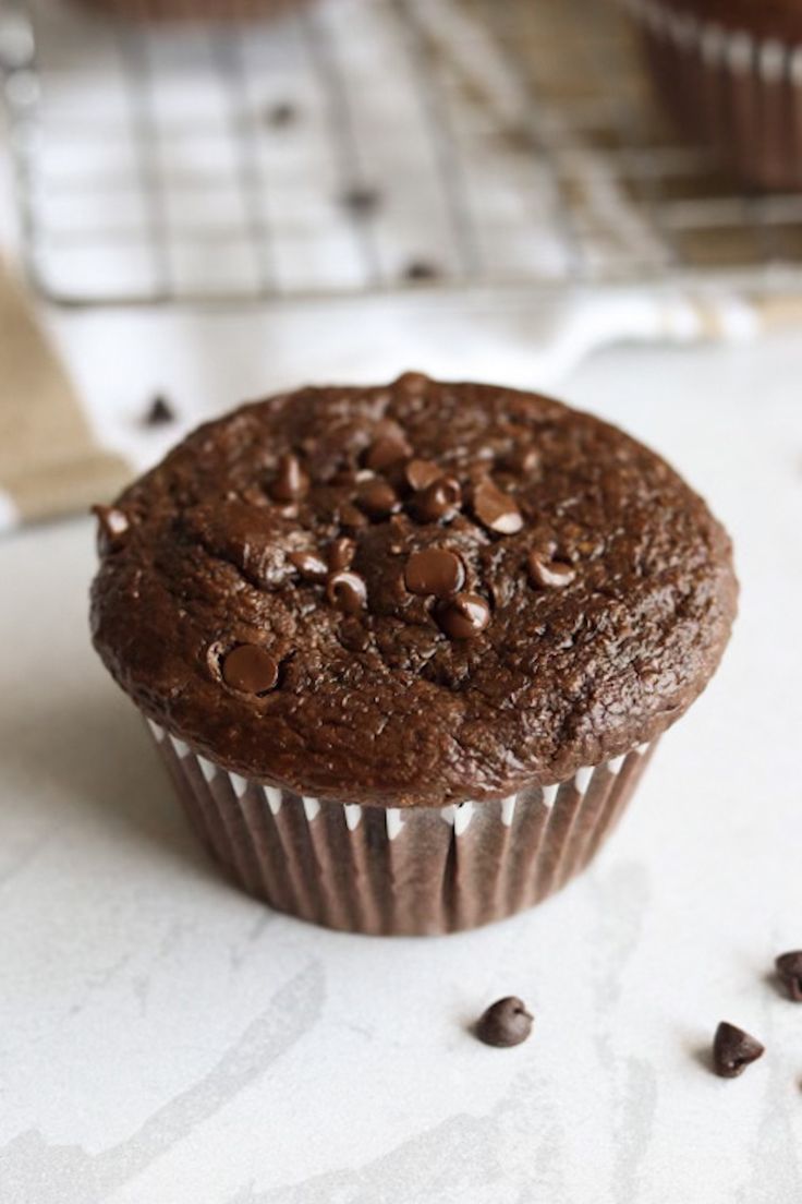 a chocolate muffin sitting on top of a counter