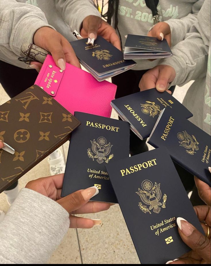 several people holding passport cards in their hands