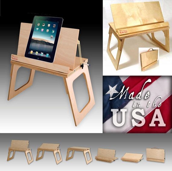 the wooden table and chair are made in the usa with an ipad on it's stand