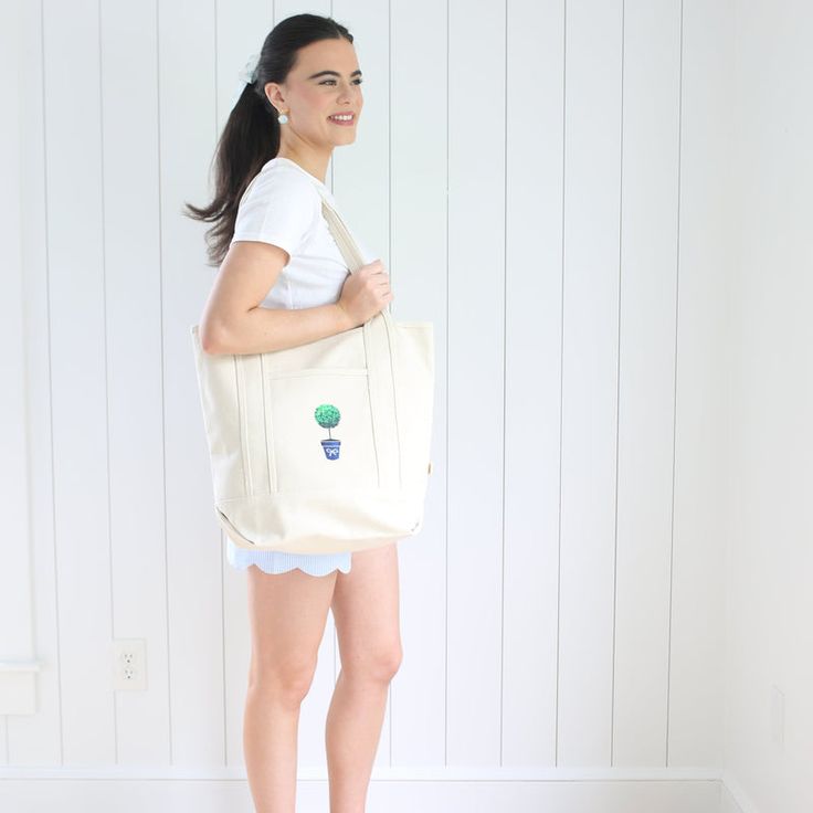 The natural canvas tote bag with the topiary design on the front pocket is definitely a one of a kind! You will have so much fun using this bag for all sorts of activities. It is perfect for running errands, using at the market, carrying your laptop, holding gardening supplies, taking to the pool, toting to the beach or filling up clothes for a weekend get-away.