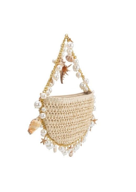 Lucrezia Raffia Shoulder Bag is a must-have accessory. Made with durable raffia, this bag features a stunning cluster shell and pearl design. Elevate any outfit with this elegant and unique shoulder bag. Gleaming shells and starfish charms dangle from this crescent-shaped shoulder bag crafted from lightweight raffia Summer Shoulder Bag With Pearl Handle, Beige Shoulder Bag With Pearl Handle For Vacation, Chic Straw Beach Bag With Pearl Handle, Summer Pearl Handle Clutch Shoulder Bag, Chic Straw Bag With Pearl Handle For Beach, Cream Beach Bag With Pearl Handle, Summer Clutch Shoulder Bag With Pearl Handle, Chic Straw Bag With Pearl Handle For Vacation, Chic Beach Straw Bag With Pearl Handle