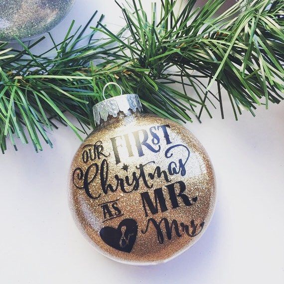 a christmas ornament with the words our first christmas is mr and mrs on it