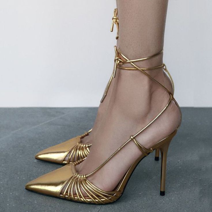 Step into the spotlight with our Gold Lace-Up Metallic High Heels. These elegant pointed-toe prom shoes feature a stunning design and are perfect for making a glamorous statement. Color: Gold Material: Metallic finish Heel Type: Stiletto heel Heel height: 4.72" / 120 mm approx Product measurements were taken using size 8. Please note that measurements may vary by size. Toe: Pointed toe The stiletto pumps with a glamorous gold metallic finish and a sexy strappy design. Handcrafted US sizing. Fits true to size. Gold Prom Shoes, High Heels Elegant, Metallic High Heels, Red Carpet Party, Heels Elegant, Shoes Heels Classy, Animal Print Shoes, Gold Wrap, Heels Classy