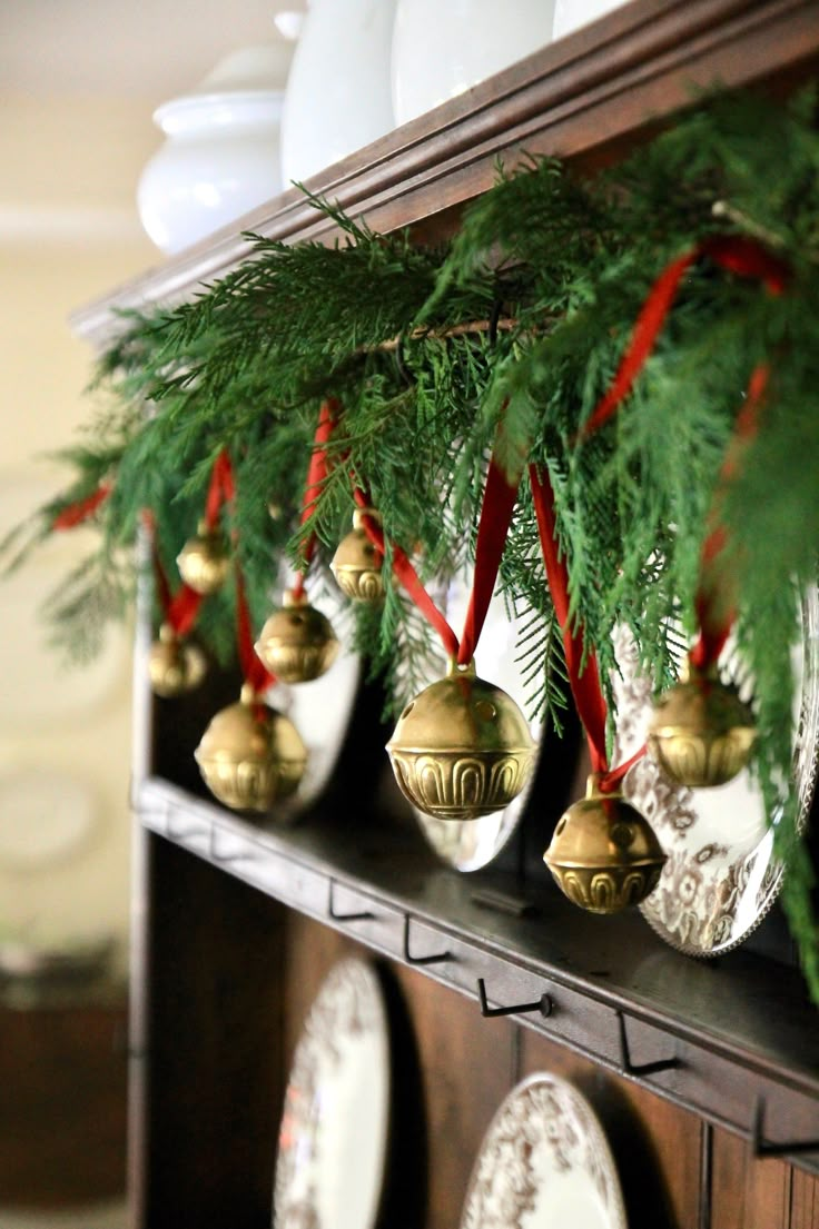 christmas ornaments are hanging on the mantle